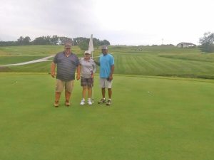 Golf Course Superintendent Tim Rogers (left) and Assistant Superintendent Ron Brown (right) pose for a picture on hole No. 12 with Sherry Shannon. Contributed image