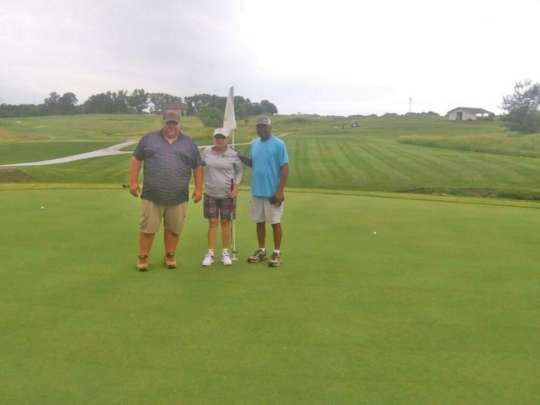 Golf Course Superintendent Tim Rogers (left) and Assistant Superintendent Ron Brown (right) pose for a picture on hole No. 12 with Sherry Shannon. Contributed image