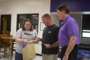 On Monday, Aug. 22, Joey Gochenour (middle) is recognized and presented with a plaque at the Slater School Board meeting by new Board President Jayme England (left) and Superintendent Terry Lorenz (right). Danielle Linton-Hatfield/Democrat-News
