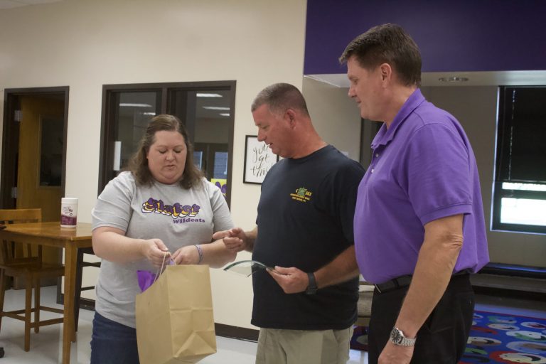On Monday, Aug. 22, Joey Gochenour (middle) is recognized and presented with a plaque at the Slater School Board meeting by new Board President Jayme England (left) and Superintendent Terry Lorenz (right). Danielle Linton-Hatfield/Democrat-News