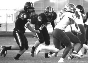 Boonville’s Dakota Troost (11) was a handful all night for the Marshall Owls’ defense to try to track down and tackle. Here, Owls’ junior Chris Davis (68) and junior Nick Arnold (58) try to move in and bring him down. Troost accounted for the bulk of the Pirates’ offense, whether it was on the ground or through the air receiving passes from senior quarterback Colby Caton. The Owls will try to get their first win this season when they travel to Richmond to take on the Spartans at 7 p.m. Friday. Hobby King/Democrat-News