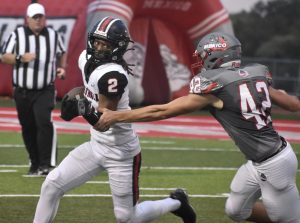 Owls’ senior wide receiver Christian Tatum (2) tries to break the tackle of Mexico senior safety Morgan Grubb. Tatum had a big night with 11 catches for 152 yards, including a 53-yard bomb, but Marshll lost the North Central Missouri Conference game 35-14. Hobby King/Democrat-News