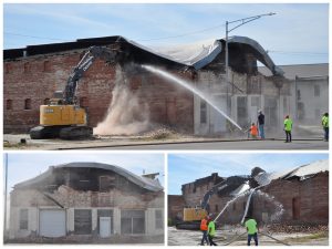 Several crew members sprayed water onto the condemned Arrow Street building Tuesday, Oct. 4, during the beginning stages of its demolition. After tearing out materials for a few minutes, they let dust settle before beginning again. Several streets in the immediate area were blocked off to thru traffic. Photos by Sarah Gray/Democrat-News