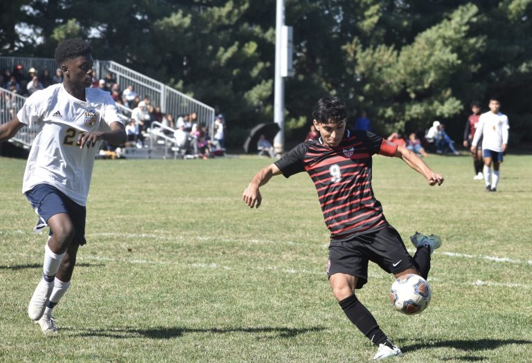 Marshall senior Derick Juarez (9) tries to put a shot on net despite the effort of Battle junior Prince Kahebwa. Juarez netted a hat trick, helping the Owls avenge the only blemish on their otherwise perfect record with a 7-2 win Saturday. Hobby King/Democrat-News