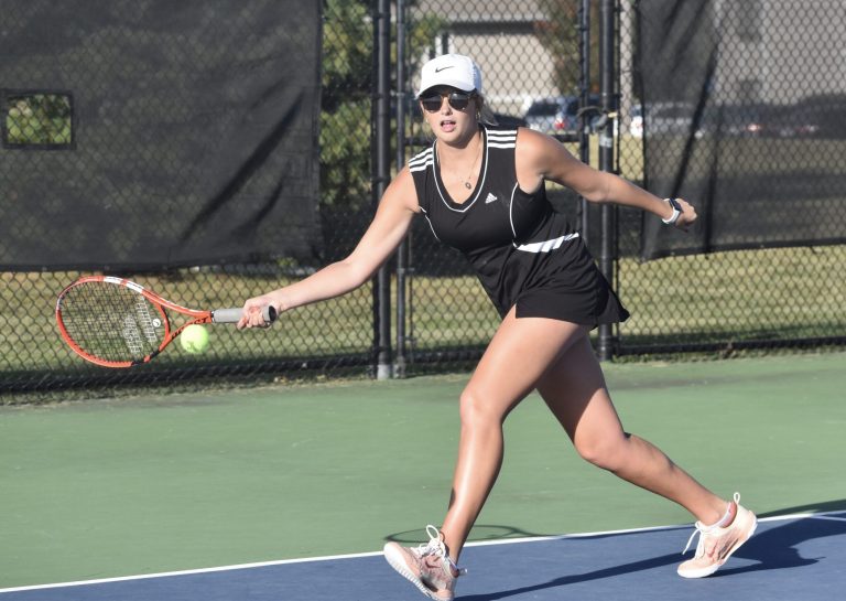 Hobby King/DeMarshall Lady Owl junior Bailey Kueker returns a shot in a district doubles match. Kueker and junior teammate Alizah Russell won their match versus Higginsville in the team district final, but the Lady Owls lost the match 5-2 Wednesday. Hobby King/Democrat-News