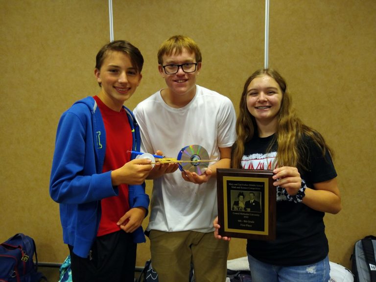 Bueker Middle School students from “Red Team” holding their first place mousetrap car on Tuesday, Oct. 18, from left to right are: Teddy Papreck, Tyler Brooks, Marlee Fuchs. Contributed image