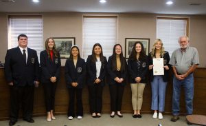 Marshall Mayor Dewey Hendrix reads a proclamation for DECA Month on Tuesday morning, Nov. 1. The proclamation was presented to the Saline County Career Center DECA chapter at 11:45 a.m. Pictured left to right are: Devin Hughes; Gentrie Davis; Jaedyn Borja; Kaylen Alvarez; Michelle Lin; Avery Evans; Bailey Kueker, SCCC DECA president and SAT officer; and Hendrix. Danielle Linton-Hatfield/Democrat-News