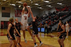 Marshall freshman Brody Kueker scores two of his co-team-high 14 points in the Owls’ 52-42 win over Odessa Wednesday. It was the first win of the season for the Owls and first-year head coach Lane Titus. (Hobby King/Democrat-News)