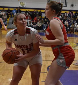 Santa Fe junior Kam Dankenbring (12) looks to get off a shot over a Lady Trojan defender in Saturday’s title game at the Slater Wildcat Classic. Dankenbring scored 12 points, including two crucial free throws down the stretch, as the Lady Chiefs beat Carrollton 41-31. (Hobby King/Democrat-News)
