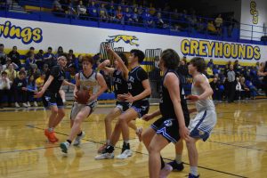 Sweet Springs junior Tanner Dohrman (24) splits Mules’ defenders on a drive to the basket. Dohrman led the Greyhounds with three three-pointers and 19 points. But Sweet Springs lost the I-70 Conference matchup 71-50 Friday. (Hobby King/Democrat-News)