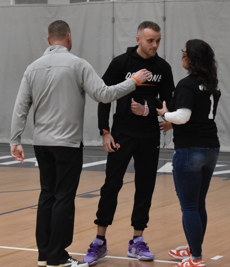 Eight days after suffering a cardiac episode that nearly cost him his life, Valley sophomore point guard Jace Lance (middle) was at the Vikings’ last home game of the year Saturday versus Peru State. He is pictured here with his father, Valley head coach Chad Lance, and his mother, Ellen Lance. (Hobby King/Democrat-News)