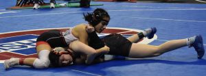 MHS senior Milandi Linares (top) gains the upper hand versus sophomore Kaiden Conard of El Dorado Springs in the second round of wrestlebacks. Linares won 100-pound match by fall. (Hobby King/Democrat-News)