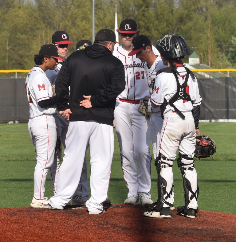 Owls’ head coach Paul Alberson meets with pitcher Ian Miles and the rest of the infield during the game versus Warrensburg Thursday. The Tigers rallied from a 5-0 deficit to clip the Owls 7-5. (Hobby King/Democrat-News)