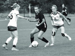 Lady Owl freshman Jadyn Jenkins (middle) tries to possess the ball and split two Southern Boone defenders. Jenkins scored a goal, but Marshall lost 7-2 in the Class 2, District 7 semifinal game at Boonville Wednesday. (Hobby King/Democrat-News)