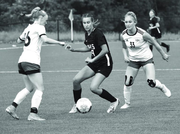 Lady Owl freshman Jadyn Jenkins (middle) tries to possess the ball and split two Southern Boone defenders. Jenkins scored a goal, but Marshall lost 7-2 in the Class 2, District 7 semifinal game at Boonville Wednesday. (Hobby King/Democrat-News)
