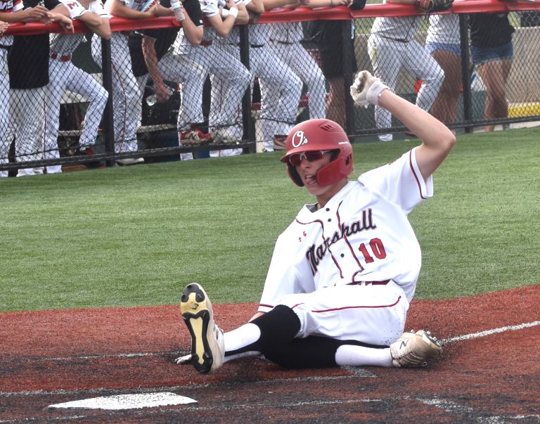 Owl junior Aiden Coffman slides across home plate with one of Marshall's three runs in the fourth inning. Coffman scored twice, but the Owls came up short, 6.4. (Hobby King/Democrat-News)