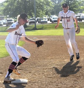 MHS freshman first baseman Brody Kueker (right) made a couple of big plays defensively. On this one, he dove to his right, gobbled up the grounder and flipped to junior pitcher Aiden Coffman who sprinted over to first to get the out in the fifth inning. (Hobby King/Democrat-News)