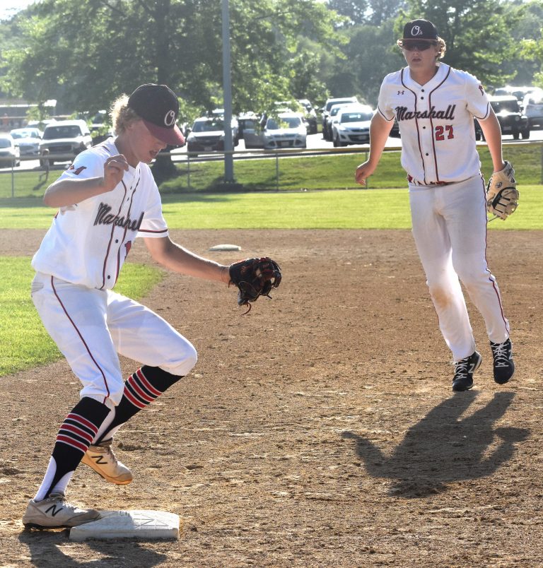 MHS freshman first baseman Brody Kueker (right) made a couple of big plays defensively. On this one, he dove to his right, gobbled up the grounder and flipped to junior pitcher Aiden Coffman who sprinted over to first to get the out in the fifth inning. (Hobby King/Democrat-News)