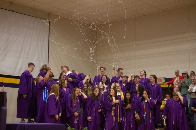 After Slater High School Class of 2023 throw off their caps Friday night, May 12, they shoot silly string into the air. Danielle Linton-Hatfield/Democrat-News