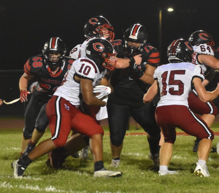 Marshall seniors Tashaun Edmund (72) and Nick Arnold (58) try to get to Chillicothe junior running back Silas Midgyett. Midgyett was held in check for the most part, and the Owls’ defense was strong in helping the Owls win the opener 19-13 last Friday. (Hobby King/Democrat-News)