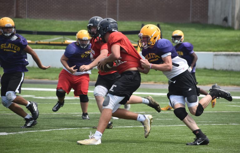 Wildcat Keiton Head attempts to bring down the Lockwood ball carrier, while Adrian Salazar plays off a block to try to get in on the tackle. (Hobby King/Democrat-News)