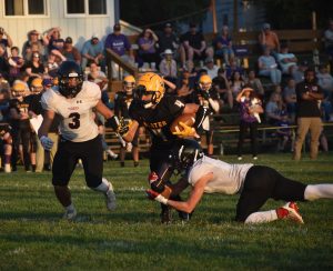 Wildcat junior Jalen Knox (4) tries to break a tackle after catching a pass versus Plattsburg. Knox scored both of Slater’s TDs on a 72-yard kickoff return and a 69-yard reception. (Hobby King/Democrat-News)