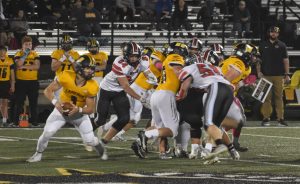 Marshall senior Henry Pointer (84) plays off a block to try to get to Cameron quarterback Alec Leazenby (3). Pointer finished with an assisted tackle in the 48-0 loss in the regular-season finale last Friday night. (Hobby King/Democrat-News)