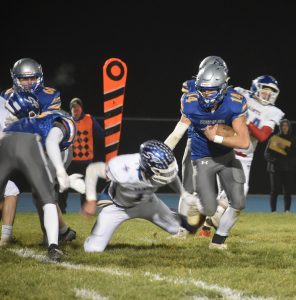 Sweet Springs senior Seth Rader (14) looks for running room as freshman Drayton Hampton (13) lays a block on the corner. Rader rushed for 188 yards and two touchdowns, but the Greyhounds dropped a 49-40 decision to Saint Paul in the 8-man District 3 title game. (Hobby King/Democrat-News)