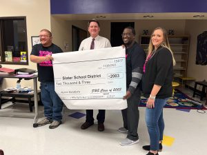Slater School District accepts a monetary donation from Slater High School Class of 2003. Pictured left to right: Caleb Jordan; Superintendent Terry Lorenz; Dominique Falls; and Alicia Eby. Danielle Linton-Hatfield/Democrat-News