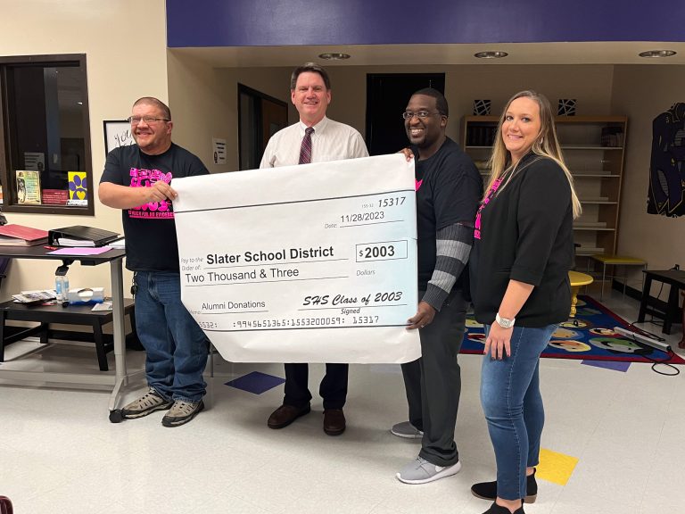 Slater School District accepts a monetary donation from Slater High School Class of 2003. Pictured left to right: Caleb Jordan; Superintendent Terry Lorenz; Dominique Falls; and Alicia Eby. Danielle Linton-Hatfield/Democrat-News