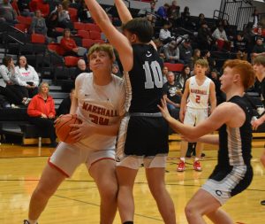 MHS sophomore Brody Kueker (34) leans in to a defender near the basket. Kueker led the Owls with 16 points in their 71-47 setback versus Centralia Thursday. (Hobby King/Democrat-News)