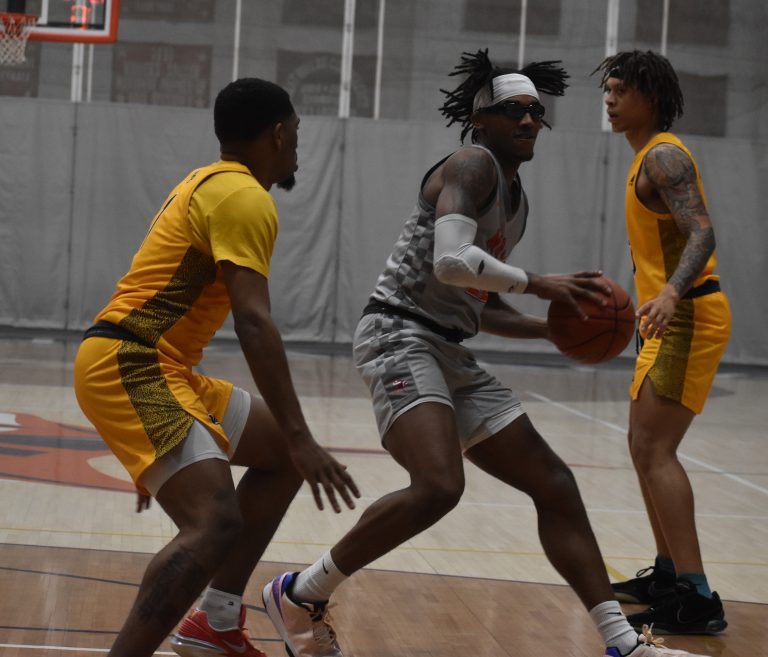 Valley junior Jarrius Burnett (middle) makes a move toward the basket., Burnett scored 13 points in the Vikings’ 81-79 win over William Penn Saturday. (Hobby King/Democrat-News)