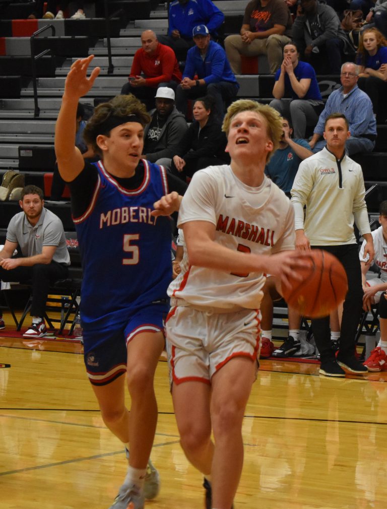 Owl senior Jaxson Case (right) drives the baseline to score two of his 15 points in the 52-46 NCMC win over Moberly. (Hobby King/Democrat-News)