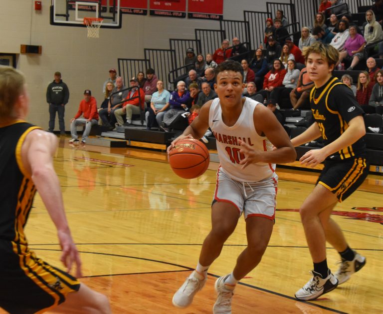 Owl junior Jayden Dominique (10) splits two Fulton defenders on his way to the basket. Dominique scored 12 points in the 61-57 NCMC setback. (Hobby King/Democrat-News)