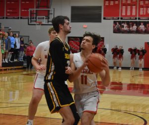 Owl senior Stephen Caviness (11) drives toward the basket versus Smith-Cotton. Caviness scored 18 points in the Owls’ first win of the season. (Hobby King/Democrat-News)