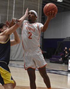Valley junior Cawhan Smith (right) scores two of his 12 points versus Mount Mercy. Smith added six assists in the Vikings’ 87-67 HAAC win last Wednesday. (Hobby King/Democrat-News)