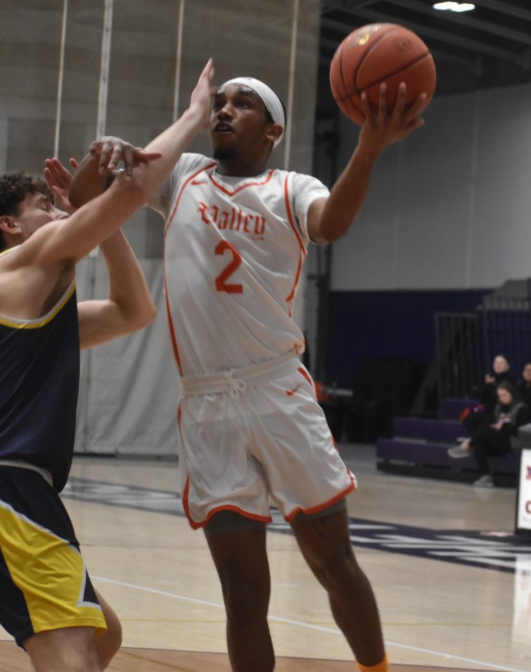 Valley junior Cawhan Smith (right) scores two of his 12 points versus Mount Mercy. Smith added six assists in the Vikings’ 87-67 HAAC win last Wednesday. (Hobby King/Democrat-News)