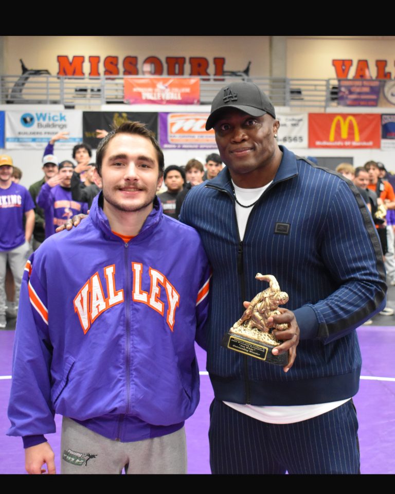 Two Missouri Valley College wrestlers won individual titles at the MVC Invitational in Marshall last Friday and Saturday. Viking senior Chase Zollman is presented the Jon White Most Outstanding Wrestler Award by MVC Athletic Hall of Fame wrestler Bobby Lashley. Zollman won all six of his matches, including two pins and two technical falls, in the 149-pound weight class. Valley finished third in the team standings. There were wrestlers from more than 40 schools at the event. (Photo courtesy of Missouri Valley College Athletics)