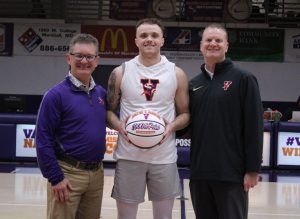 Prior to the men’s game versus Clarke, Marshall native Jace Lance (middle) received a basketball honoring him scoring his 1,000th point in a Vikings’ uniform. He was presented the ball by athletic director Mike Machholz (left) and his father and men’s basketball coach Chad Lance. (Photo courtesy MVC Athletics)