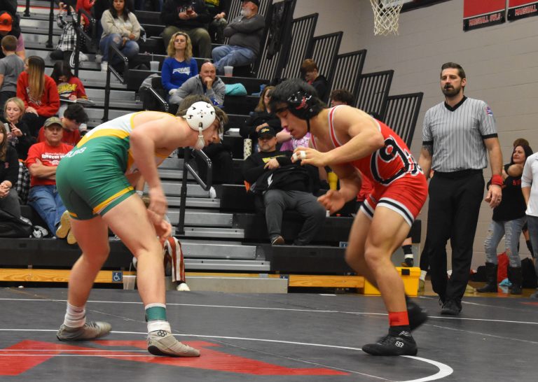 Marshall junior Mason Evans (right) prepares to lock horns with Tyler Abell of Rock Bridge in the championship match at 157. Evans dropped the title tilt by a 7-2 decision and finished second in the tournament. (Hobby King/Democrat-News)