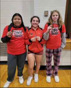The Marshall Lady Owls’ wrestling team captured two firsts and one second at the Highway 13 Throwdown last Friday. Junior Sherlyn Solano (left) won the title in the 235-pound weight class, and freshman McKenzy Mason (right) won the title in the 100-pound weight class. Junior Ayla Castaneda (middle) was second in the 155-pound weight class. (Contributed image)