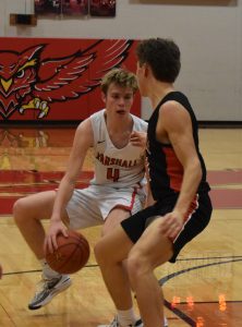 Owl sophomore Chase Thompson (4) dribbles between his legs to try to get around a Chillicothe defender. Thompson scored 12 points, but Marshall lost the non-conference game 62-47. (Hobby King/Democrat-News)