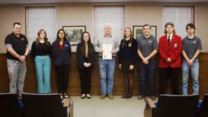 Marshall Mayor Vince Lutterbie reads a proclamation for the Saline County Career Center on Friday morning, Feb. 2, in the city council chambers. Pictured left to right are as follows: Brian Wilcoxson, SCCC director; Claire Glenn, president of EdRising; Dianna Escarate, vice president of FBLA; Michelle Lin, president of DECA; Mayor Vince Lutterbie; Gentrie Davis, president of FFA; Chayse White, student ambassador of SCCC; Carson McDonald, president of SkillsUSA; and Konner Ross, student ambassador of SCCC. Danielle Linton-Hatfield/Democrat-News