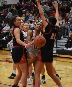 Lady Owl freshman Saniya Powell (11) tries to split two Chillicothe defenders and get a shot up in the lane. Powell scored two points in Marshall’s 63-21 non-conference loss. (Hobby King/Democrat-News)