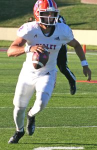 Valley freshman quarterback Cole Robertson looks for running room. Robertson rushed for 50 yards and two fourth-quarter touchdowns. He also passed for 113 yards in a 29-24 victory over Graceland on Gregg-Mitchell Field in Marshall last Saturday. (Hobby King/Democrat-News)