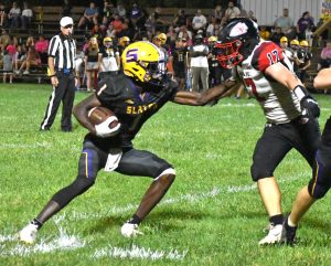 Slater senior Brandon Terrill (1) stiff-arms Santa Fe junior Ethan Finkeldei after catching a pass in a game last Friday. Terrill rushed for 97 yards and two touchdowns and caught three passes for 38 yards and two more scores. Slater blanked the Chiefs 82-0. Hobby King/Democrat-News