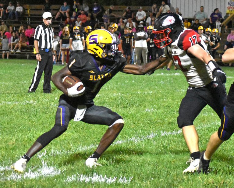 Slater senior Brandon Terrill (1) stiff-arms Santa Fe junior Ethan Finkeldei after catching a pass in a game last Friday. Terrill rushed for 97 yards and two touchdowns and caught three passes for 38 yards and two more scores. Slater blanked the Chiefs 82-0. Hobby King/Democrat-News