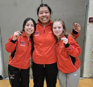 Sophomore Genavieve Ceja (left), senior Sherlyn Solano (middle) and sophomore Kendra Bellamy punched their tickets to the Class 1 State Wrestling Tournament with Top 4 placings in their weight classes at district. (Contributed image)