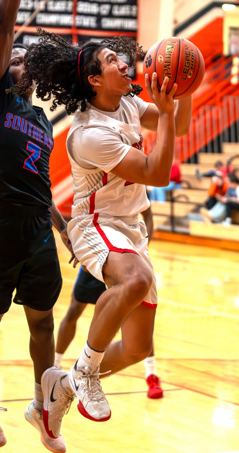 Marshall sophomore Angel Aguirre (right) gets inside position and scores two of his six points in a 66-49 win over Southeast in the first round of district play. Aguirre accounted for seven points in the Owls’ semifinal win over Paseo Academy. (Photo courtesy Tom Boehmer Photography)