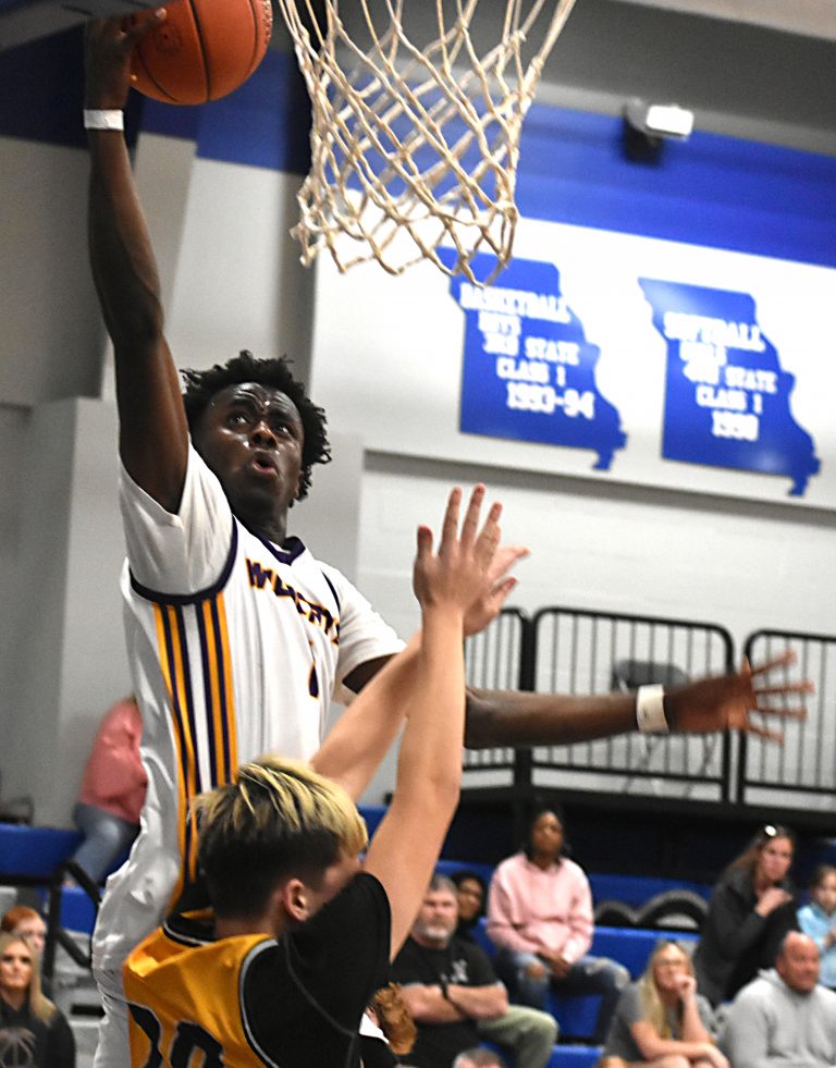Slater senior Brandon Terrill scores two points over the top of a Tiger defender. Terrill supplied three thunderous dunks in the second half and finished with a game-high 30 points in the Wildcats’ 83-44 blowout victory over Smithton in the Class 2, District 8 Tournament championship game at New Franklin last Friday night. (Hobby King/Democrat-News)